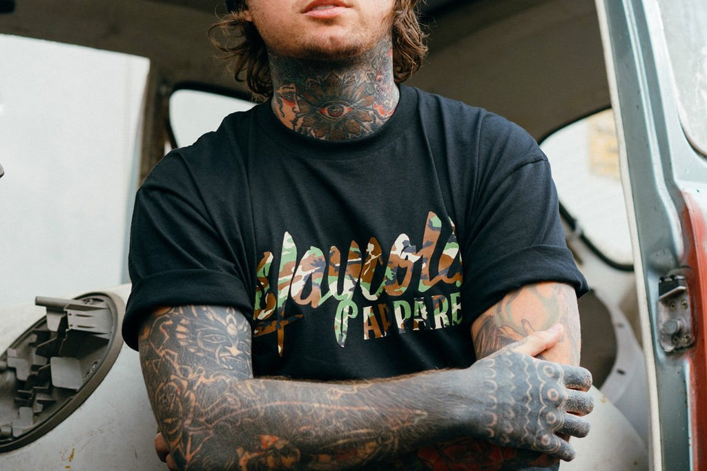 Tattooed Model in the new Stay Cold Apparel Variation of the Essential Logo Tee now in Camouflage Woodland