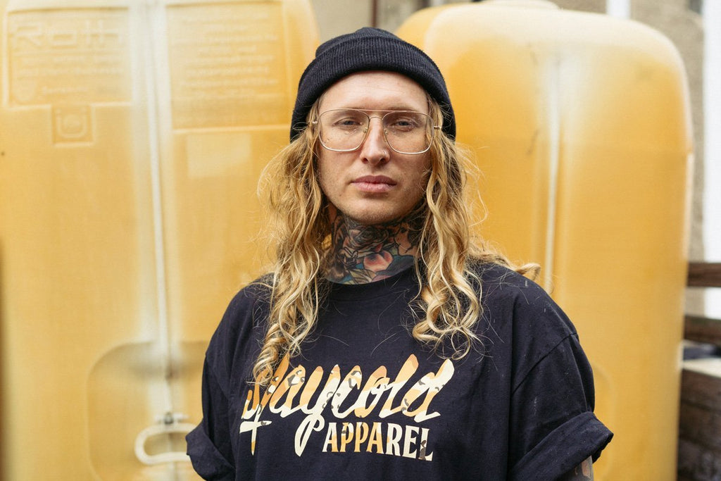 Male Tattooed Model wearing the new Stay Cold Apparel Variation of the Essential Logo Tee in Camouflage Sand